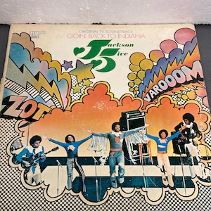 May include: A vintage vinyl record album cover featuring the Jackson 5, a popular music group from the 1970s. The cover art is colorful and features a cartoon-like design with the band members performing on stage. The album title is "Goin' Back to Indiana" and is the original TV soundtrack.