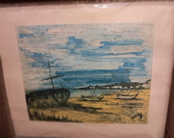 May include: A framed watercolor painting depicting a seascape with three boats on a sandy beach. The sky is a light blue with white clouds. The boats are black and white and the water is a light blue. The beach is a light yellow. The painting is signed in the bottom right corner.