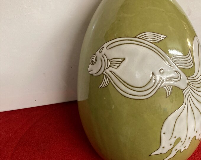 Large hand thrown vase with incised and enameled  mystical Fish over a muted green ground.