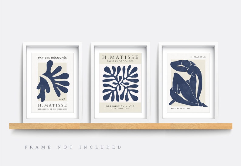 May include: Set of three blue and white art prints featuring abstract designs by Henri Matisse. The prints are titled "Papiers Decoupes" and feature a stylized plant, a geometric pattern, and a seated figure.