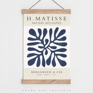 May include: A blue and white art print featuring a Matisse cut-out design. The print has the text "H. Matisse Papiers D&eacute;coup&eacute;s" and "Berggruen & Cie Jazz. Paris. 1953". The text "FRAME NOT INCLUDED" is at the bottom of the print.