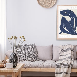 May include: A framed print of a blue abstract figure, titled "Blue Nude II, 1952" by H. Matisse.
