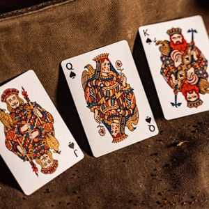 The king, queen, and jack of Spades displayed