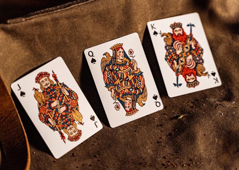 The king, queen, and jack of Spades displayed