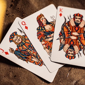 The king, queen, and jack of diamonds  displayed