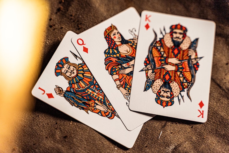 The king, queen, and jack of diamonds  displayed