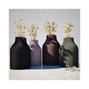 May include: Four vases with white flowers, each vase has a different color: black, pink, brown, and green. The vases have a ribbed pattern.