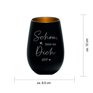 May include: A black stemless wine glass with a gold interior. The glass has the German text "Sch&ouml;n, dass es Dich gibt!" in white script. The glass is approximately 4.7 inches tall and 3.3 inches wide.