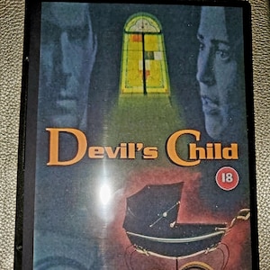 May include: A DVD case with a dark blue background and a vintage-style image of a baby carriage. The text "Devil's Child" is in large, yellow letters. The text "Evil has had many faces... Tonight there will be a new one" is in smaller, white letters.
