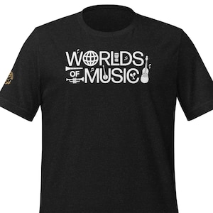 May include: Black t-shirt with white text that reads "Worlds of Music" and features musical instruments like a trumpet, drums, and a violin.