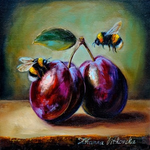 May include: Oil painting depicting two plums, a green leaf, and two bumblebees. The plums are a rich purple with highlights, and the bees are black and yellow. The painting is signed "Zhanna Vitkovska".