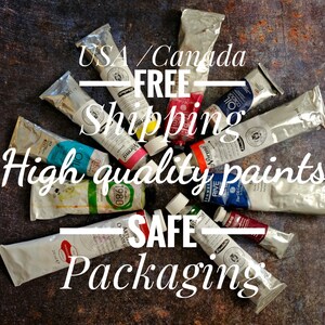 May include: A variety of tubes of oil paints arranged in a circle on a dark brown surface. The text "USA/Canada FREE Shipping High quality paints SAFE Packaging" is written in white letters on a red background.