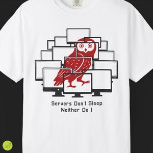 May include: White t-shirt featuring a red owl illustration surrounded by computer monitors. The text "Servers Don't Sleep Neither Do I" is printed below the graphic. A casual, comfortable tee.
