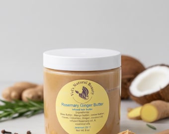 May include: A jar of Rosemary Ginger Butter with a white lid and a yellow label. The label includes the text "Vel's Natural Beauty" and ingredient information. A wooden spoon with butter is in the foreground. Ginger and coconut are in the background.