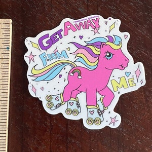 May include: A pink and purple cartoon pony wearing roller skates with a rainbow mane and tail. The pony is on a white background with the text "Get Away From Me" in pink, purple, and yellow.