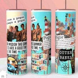 May include: A stainless steel tumbler with a colourful design featuring characters from the TV show Outer Banks. The tumbler has a blue background with palm trees, a lighthouse, and the words "Pogue" and "Outer Banks". The tumbler also features the text "Once a Pogue, Always a Pogue" and "Our Mission This Summer is to Have a Good Time All the Time".