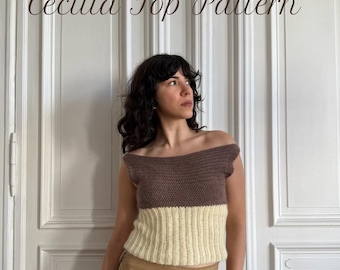 May include: A two-tone crochet top with a brown upper section and a cream-colored lower section. The off-the-shoulder top is paired with a tan skirt. The text "Cecilia Top Pattern" is displayed in a script font.