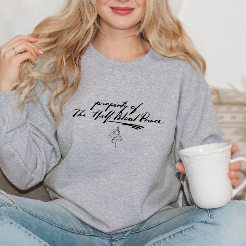 May include: Gray sweatshirt with the text "property of The Half-Blood Prince" and a snake graphic.