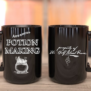 May include: Two black mugs with white text and images. One mug says "Advanced Potion Making" with a cauldron and steam. The other mug says "property of The Half-Blood Prince" with a snake.