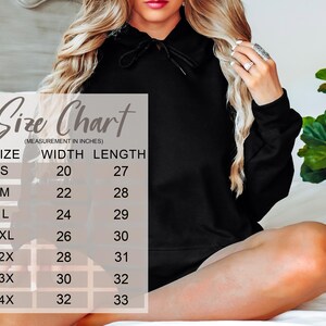 May include: Black hoodie with a drawstring neckline. A size chart in inches is displayed, showing measurements for sizes S to 4X. The chart includes width and length dimensions for each size, with the smallest size having a width of 20 inches and a length of 27 inches.