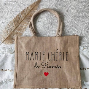 May include: A brown burlap tote bag with black text that reads "MAMMIE CH&Eacute;RIE de Rom&eacute;o" and a red heart.