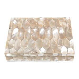 May include: Rectangular decorative box with a mother-of-pearl mosaic design. The box features a hinged lid and is composed of iridescent, hexagonal tiles in shades of cream and beige. The box is a decorative storage item.