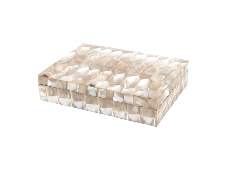 May include: Rectangular decorative box with a mother-of-pearl mosaic design. The box is a light beige color and has a hinged lid. The mosaic pattern is made up of small, irregular shapes. The box is likely used for storing jewelry or small items.