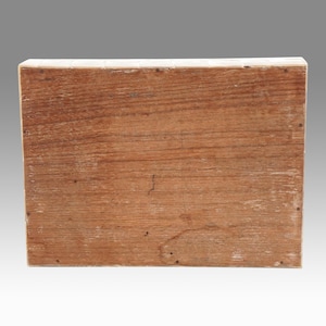 May include: A rectangular wooden box with a natural wood grain finish. The box is constructed from planks of wood, with visible nail heads along the edges. The wood has a warm, reddish-brown hue.