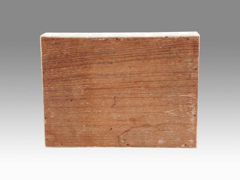 May include: A rectangular wooden box with a natural wood grain finish. The box is constructed from planks of wood, with visible nail heads along the edges. The wood has a warm, reddish-brown hue.