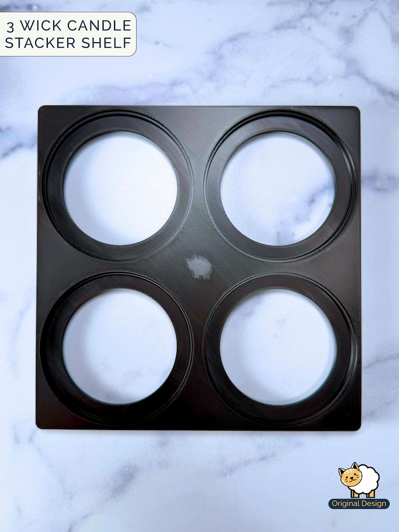 May include: A square black 3 wick candle stacker shelf with four circular cutouts arranged in a grid. The text 3 WICK CANDLE STACKER SHELF is visible in the top left corner, and a small sheep icon with the text Original Design is in the bottom right.