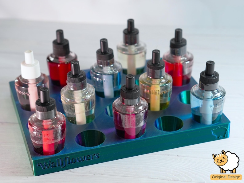 May include: A blue plastic rack with 10 glass bottles with black caps and colorful liquids. The rack has the word "Wallflowers" printed on the front.