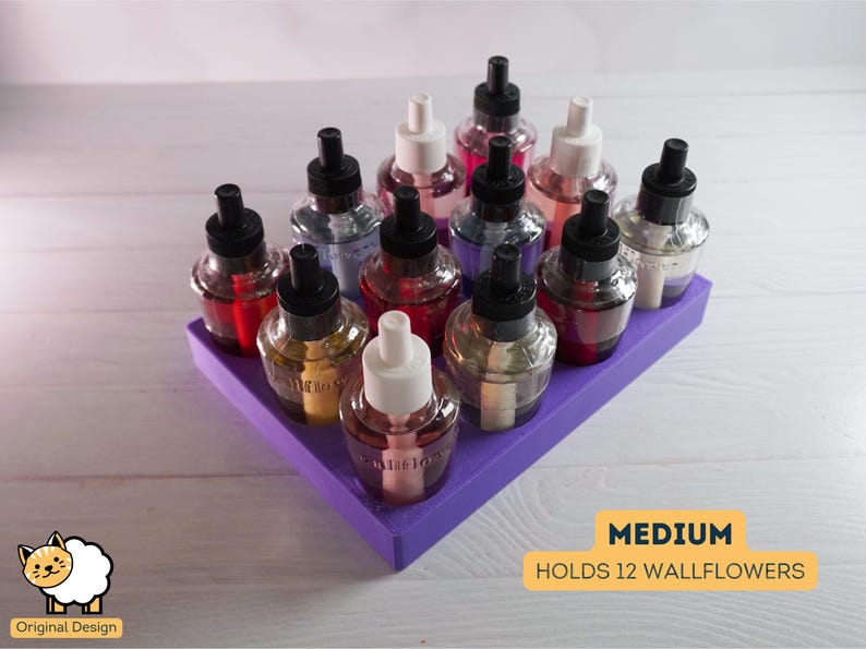 May include: A purple wallflower holder with 12 glass bottles filled with scented oil. The holder is labeled "MEDIUM HOLDS 12 WALLFLOWERS".