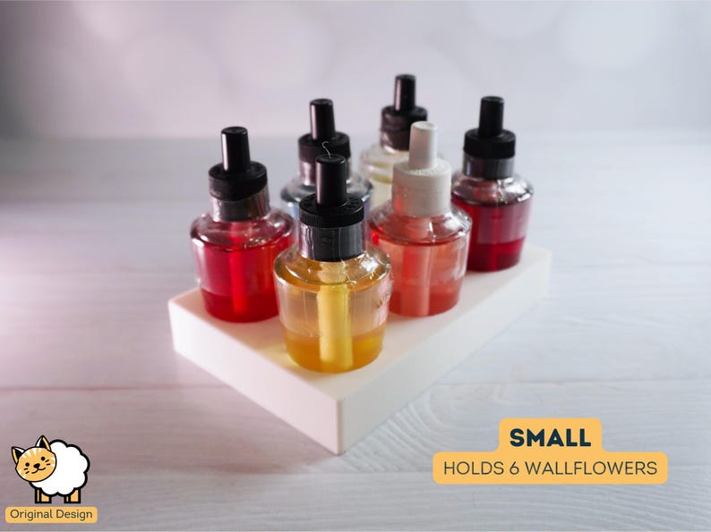 May include: A white plastic holder for six wallflower fragrance refills. The holder is small and has a rectangular shape. The holder is filled with six different colored wallflower refills, including red, yellow, and clear.