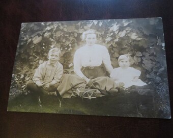 RPPC Antique Real Photo Postcard / Mother and Children seated with Child's Toys