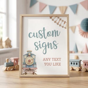 Puede incluir: Un letrero enmarcado con las palabras "custom signs" en escritura turquesa. Debajo, se lee "ANY TEXT YOU LIKE". Una ilustración de tren en acuarela y vías de tren decoran el letrero. Trenes de juguete de madera en el fondo.