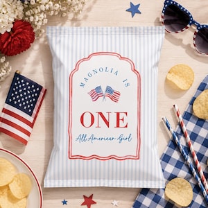 May include: A bag of chips with a patriotic design, featuring the text "MAGNOLIA IS ONE All American Girl" in red and blue. The image includes an American flag, sunglasses, and decorative elements.