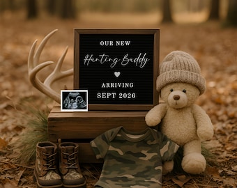 May include: A black letter board with white text reading OUR NEW Hunting Buddy ARRIVING SEPT 2026, an ultrasound image, a tan teddy bear wearing a beanie, a pair of camouflage boots, and a camouflage baby bodysuit on a wooden crate.