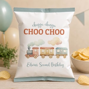 May include: White chip bag with a watercolor train illustration and the text "chugga chugga CHOO CHOO". Below the train is the text "Edwin's Second Birthday". The bag has a blue and white striped border.