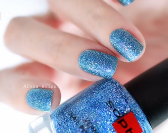 Blue holographic nail polish. Sophin 0375 CINDERELLA. Diffuse holographic filled with lots of sparkling prismatic particles. 3D effect.