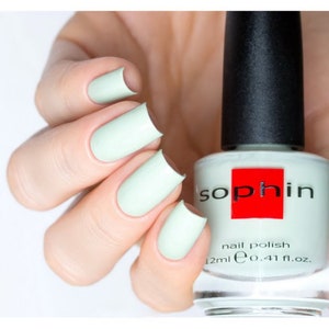 May include: A bottle of light green nail polish with the brand name "Sophin" in red letters. The bottle is 12 ml or 0.41 fl. oz.