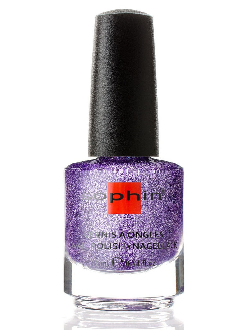 May include: A bottle of purple nail polish with a silver glitter finish. The bottle is labeled "Vernis a Ongles Polish Nagellack" and has a red square with the word "Sophin" on it.