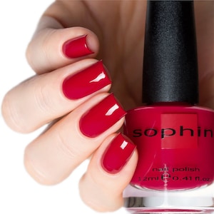 May include: A red nail polish bottle with the brand name "Sophin" and the text "nail polish 12ml 0.41 fl.oz."
