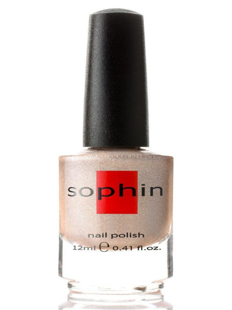 May include: A bottle of Sophi nail polish in a shimmery champagne color. The bottle is 12 ml or 0.41 fl. oz.