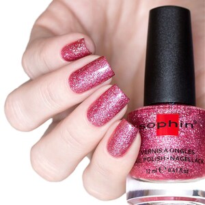K&ouml;nnte beinhalten: Eine Flasche rosa Glitzer-Nagellack mit dem Markennamen "Sophin" auf dem Etikett. Die Flasche ist 12 ml (0.47 fl oz) gro&szlig;.