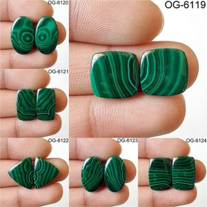 May include: Set of two green malachite cabochons, each with a unique swirling pattern. The stones are oval, square, and rectangular in shape.