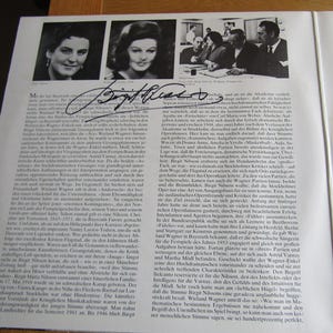 May include: A page from a book featuring a black and white photograph of three people, a signature, and printed text. The image includes a portrait of a woman and a group of people.