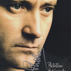 May include: A portrait of Phil Collins with a serious expression, featuring a dark background and the text Phil Collins ...But Seriously printed in white, along with a grey signature overlaying the lower portion of the image.