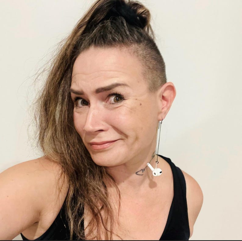 Woman wearing our bluetooth amplifier or airpod retention chain that keeps the airpod attached at the ear so it prevents it from falling to the ground