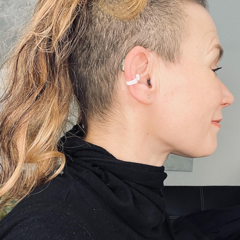 Our Deafmetal insurance flexi clip shown from a side angle on a woman