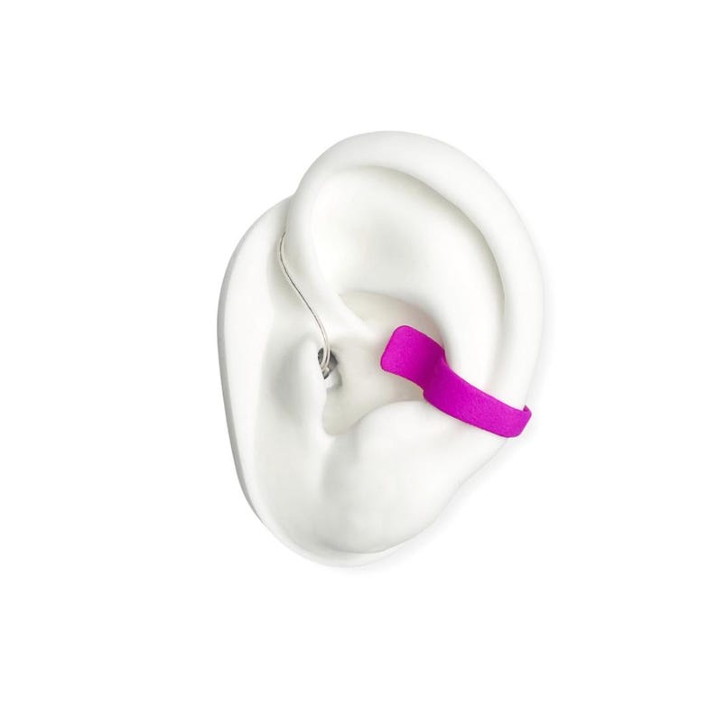 deafmetal insurance flexi clip shown on a white silicone ear and the color of the clip is pink or fuschia